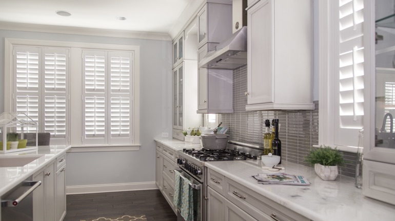 Plantation shutters in Philadelphia kitchen with modern appliances.